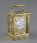 An early 20th century silvered and ormolu hour repeating carriage clock, with enamelled Roman dial
