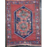 An Afshar rug, with central stepped motif, on a red ground, with three row border, 5ft 8in by 4ft