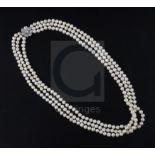 A triple strand freshwater? pearl necklace with white gold and diamond cluster set clasp, 68cm.