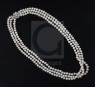 A triple strand freshwater? pearl necklace with white gold and diamond cluster set clasp, 68cm.