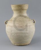 A Chinese pale green glazed jar, Han dynasty, with wavy bands to the neck and a pair of applied