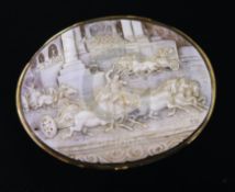 A large Victorian gold mounted oval cameo brooch, carved with scene of racing chariots, initialled