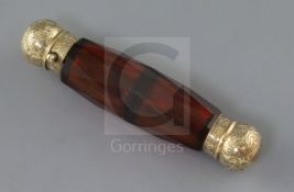 A Victorian engraved gold mounted double ended facet cut ruby glass scent bottle, the interior of