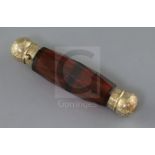 A Victorian engraved gold mounted double ended facet cut ruby glass scent bottle, the interior of