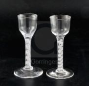 Two double series opaque twist stem cordial glasses, c.1760, each with a bucket shaped bowl and