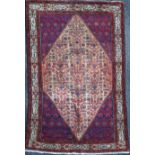 A Malayer rug, with filled of foliate motifs, on a red/blue ground, 6ft 6in by 4ft 6in.