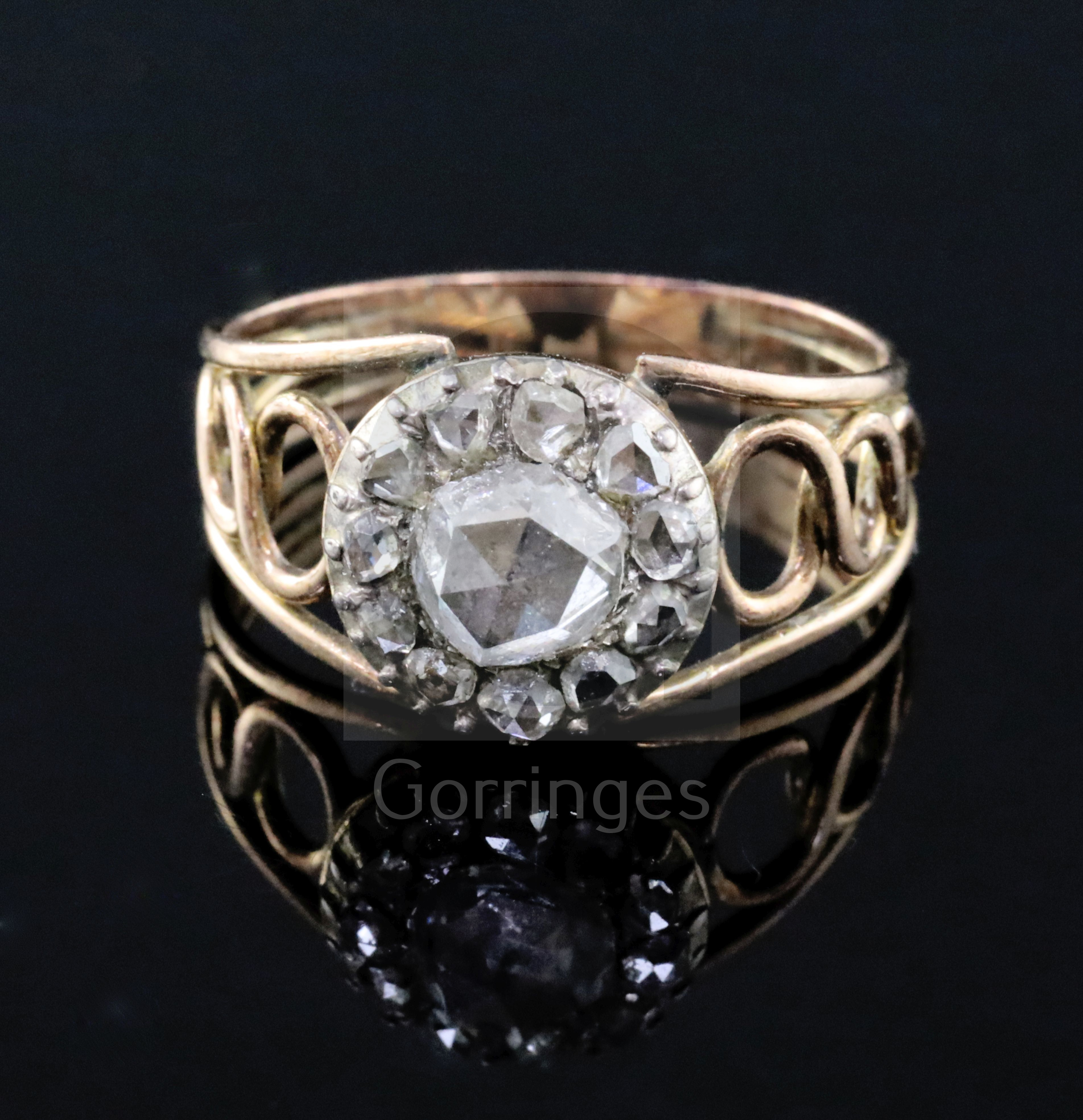 A Georgian gold, silver and rose cut diamond set cluster dress ring, with reeded and pierced