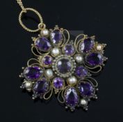 A Victorian gold, amethyst and split pearl set quatrefoil pendant, on a 9ct gold fine link chain,