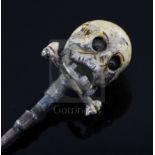 A 19th century French? base metal and cream enamel skull head stick pin, in the manner of Trouve &