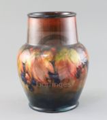 A Moorcroft 'leaf and berry' flambe vase, 1930's, with a tapering cylindrical neck above a