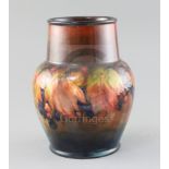 A Moorcroft 'leaf and berry' flambe vase, 1930's, with a tapering cylindrical neck above a