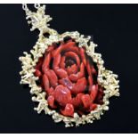 A modernist gold and carved coral oval pendant, with branch-effect mount on gold chain (tests as