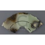 A Chinese archaistic jade fan shaped plaque, the pale celadon stone with brown and black inclusions,