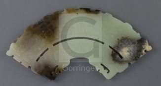 A Chinese archaistic jade fan shaped plaque, the pale celadon stone with brown and black inclusions,