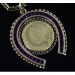 A gold and synthetic ruby? set horseshoe pendant with inset with 1899 United States of America