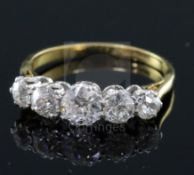 An 18ct gold and platinum, graduated five stone diamond half hoop ring, size M.