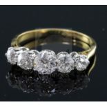 An 18ct gold and platinum, graduated five stone diamond half hoop ring, size M.