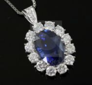 A platinum-set sapphire and diamond oval cluster pendant on 18ct white gold chain, pendant 28mm