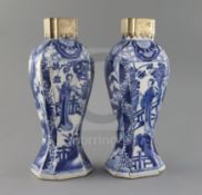 A pair of Chinese blue and white canted rectangular baluster vases, Kangxi period, each painted with