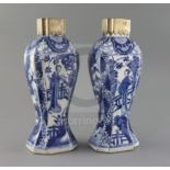A pair of Chinese blue and white canted rectangular baluster vases, Kangxi period, each painted with
