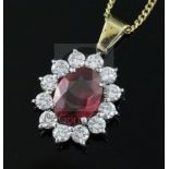 An 18ct gold and platinum ruby and diamond cluster pendant on 18ct gold fine chain, pendant 12mm.