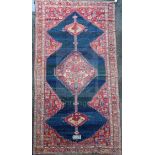 An antique Karabagh carpet, dated 1892, with stepped motifs on a red ground, with three row