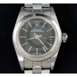 A lady's late 1990's stainless steel Rolex Oyster Perpetual wrist watch, with black dial and baton