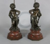 A pair of Victorian bronze figures of putti, with the accoutrements of an archer and a fisherman, on