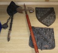 A collection of stage weapons and two shield shaped metal panels