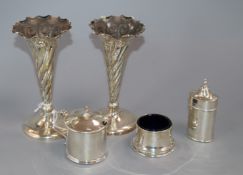 A pair of silver trumpet vases (weighted) and a three-piece silver condiment set.