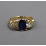 A yellow metal, sapphire and diamond three stone ring (two small diamonds missing and re-sized),