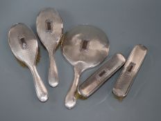 A five-piece silver-mounted dressing table set.