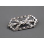 A mid 20th century white metal and diamond cluster set openwork hexagonal brooch, 33mm.