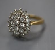 A diamond cluster ring , the oval set with 26 brilliants in three tiers, 18ct yellow gold setting