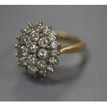 A diamond cluster ring , the oval set with 26 brilliants in three tiers, 18ct yellow gold setting