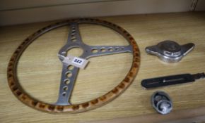 A vintage AC wheel spinner, badge and steering wheel