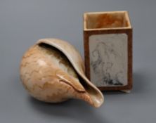 A conch shell and a brush pot