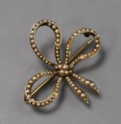 A 14k yellow metal and seed pearl set bow brooch, 37mm.