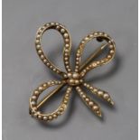 A 14k yellow metal and seed pearl set bow brooch, 37mm.