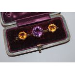 An early 20th century yellow metal, amethyst and citrine three stone bar brooch, 52mm.