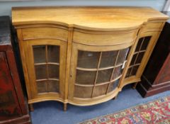 An early 20th century mahogany serpentine dwarf side cabinet W.124cm