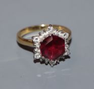 A garnet and diamond hexagonal cluster ring on 18ct yellow gold shank, size M.