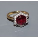 A garnet and diamond hexagonal cluster ring on 18ct yellow gold shank, size M.