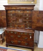 A George I feather banded walnut cabinet on chest W.110cm