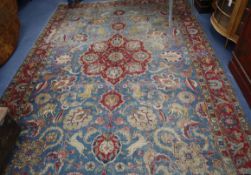 A Tabriz pale blue ground carpet, woven with hunting animals and floral medallions 350 x 240cm