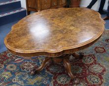 A Victorian burr walnut oval loo table, on quadruple ball and claw base Size of top is 150cm