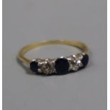 An 18ct, graduated sapphire and diamond five stone half hoop ring, size P.