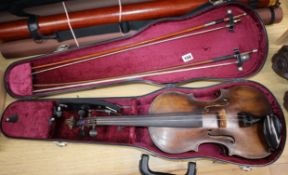 A cased violin and two bows