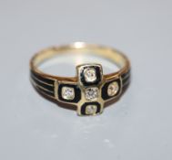 A 19th century yellow metal, black enamel and old cut diamond set mourning ring, size P.