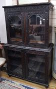 A 19th century Anglo Indian carved Padouk glazed four door cabinet W.115cm